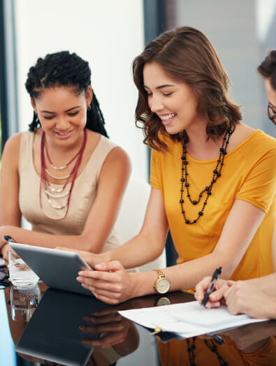 Two colleagues reviewing coverage on a tablet